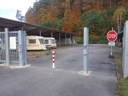 Abstellplatz - Deutschland - Absperrbake zur Zufahrtskontrolle, Überwachungskamera oben links im Bild ersichtlich - Einstellplätze im Solarpark Dahn bei Firma Gethmann-Becker-Pötsch GbR